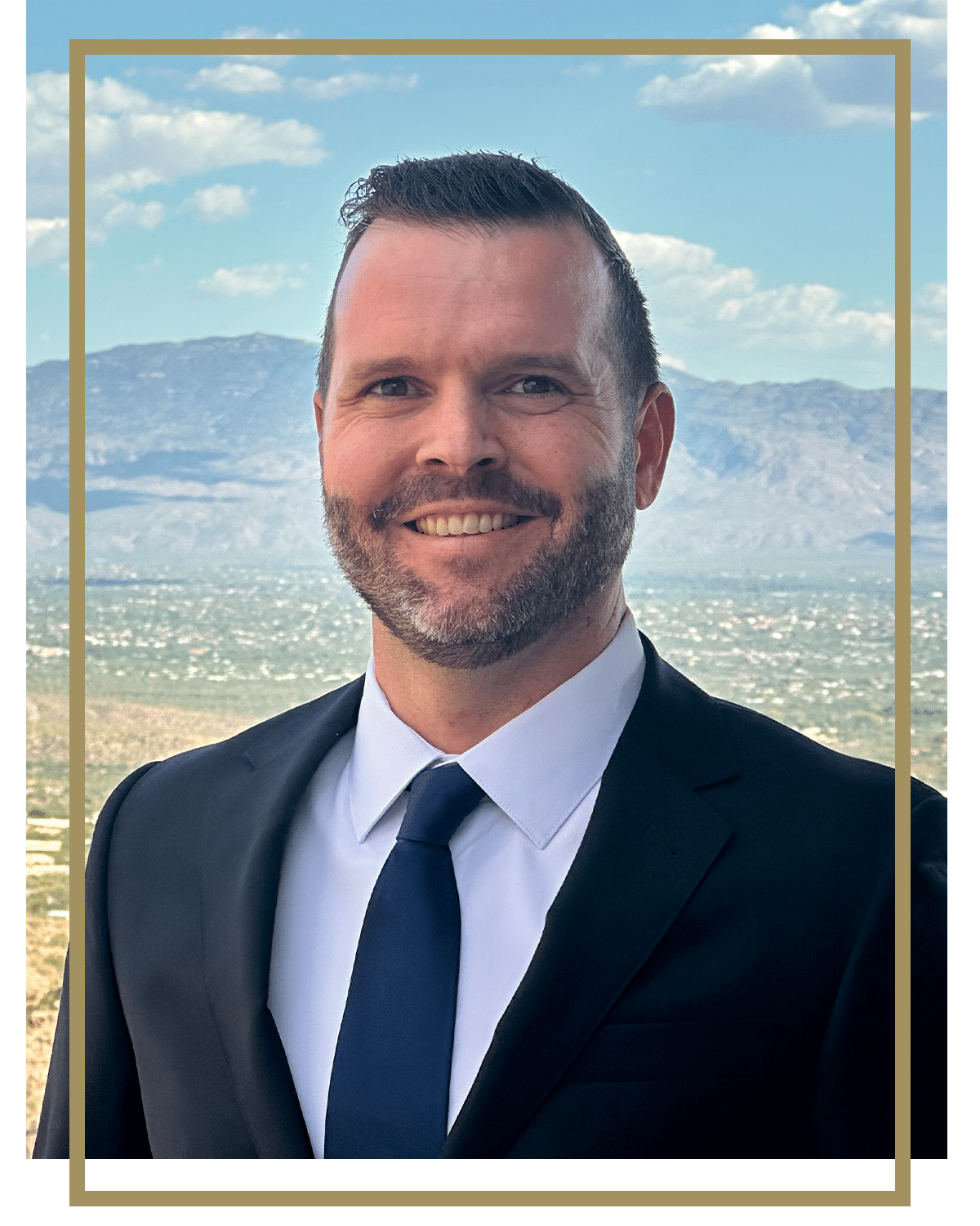 a man wearing a suit and tie smiling at the camera